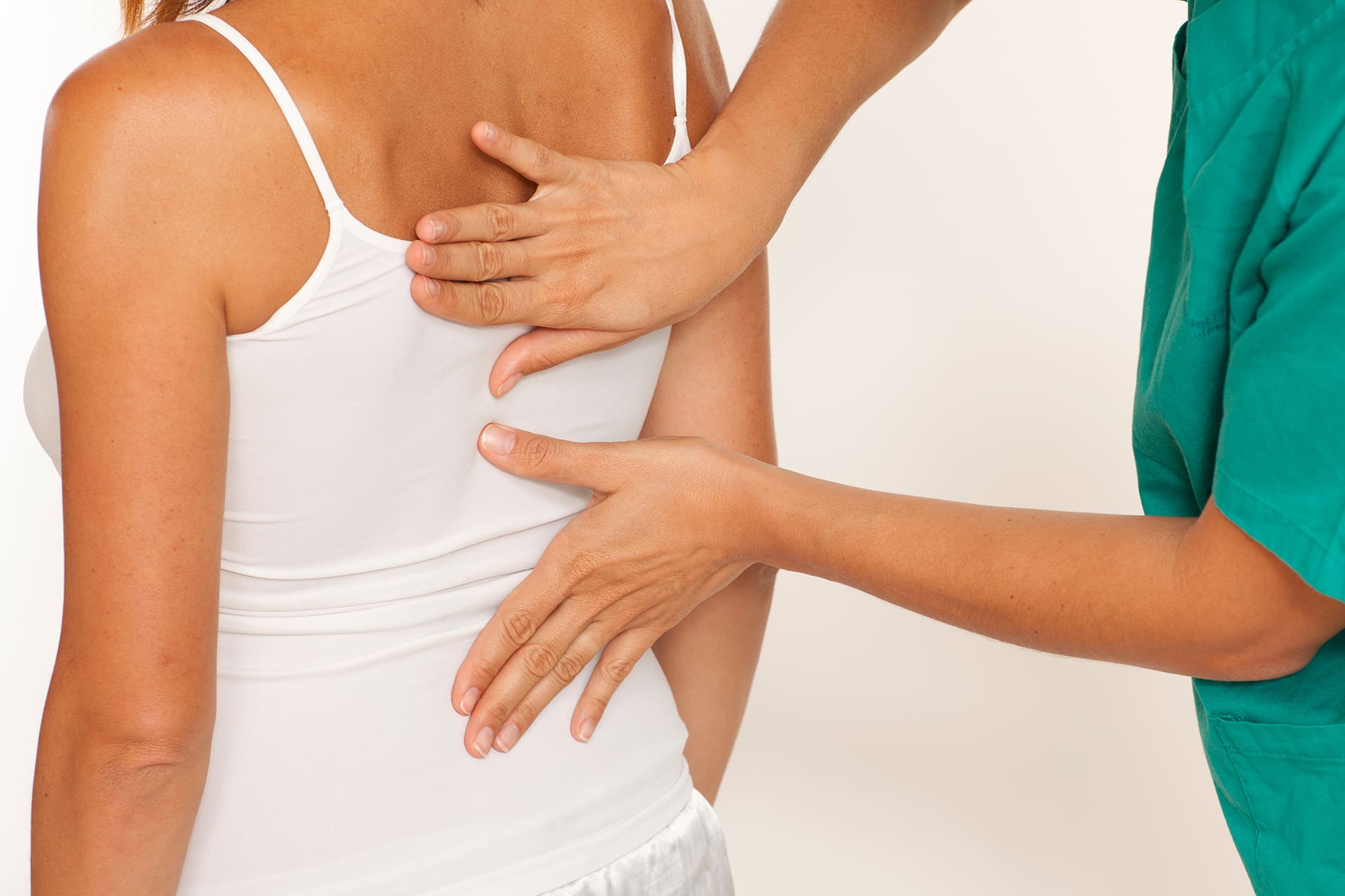 a chiropractor treating a woman with back pain