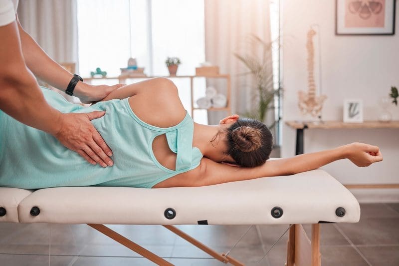 A woman undergoing therapy at a chiropractic clinic.